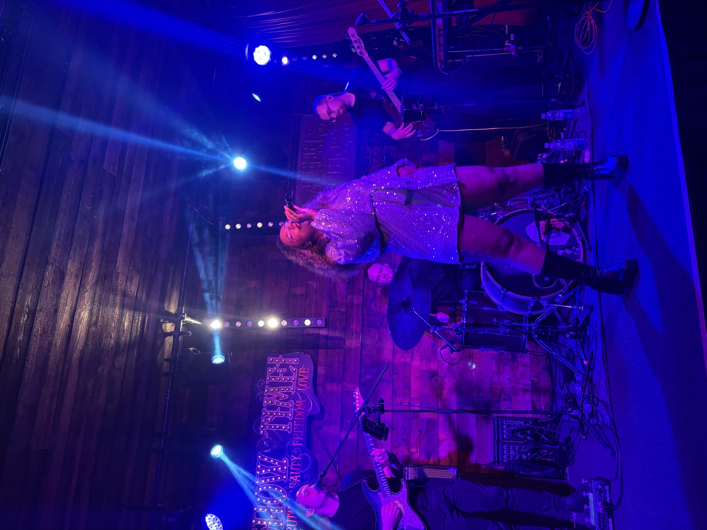 Nicole Battick performing with her band on stage