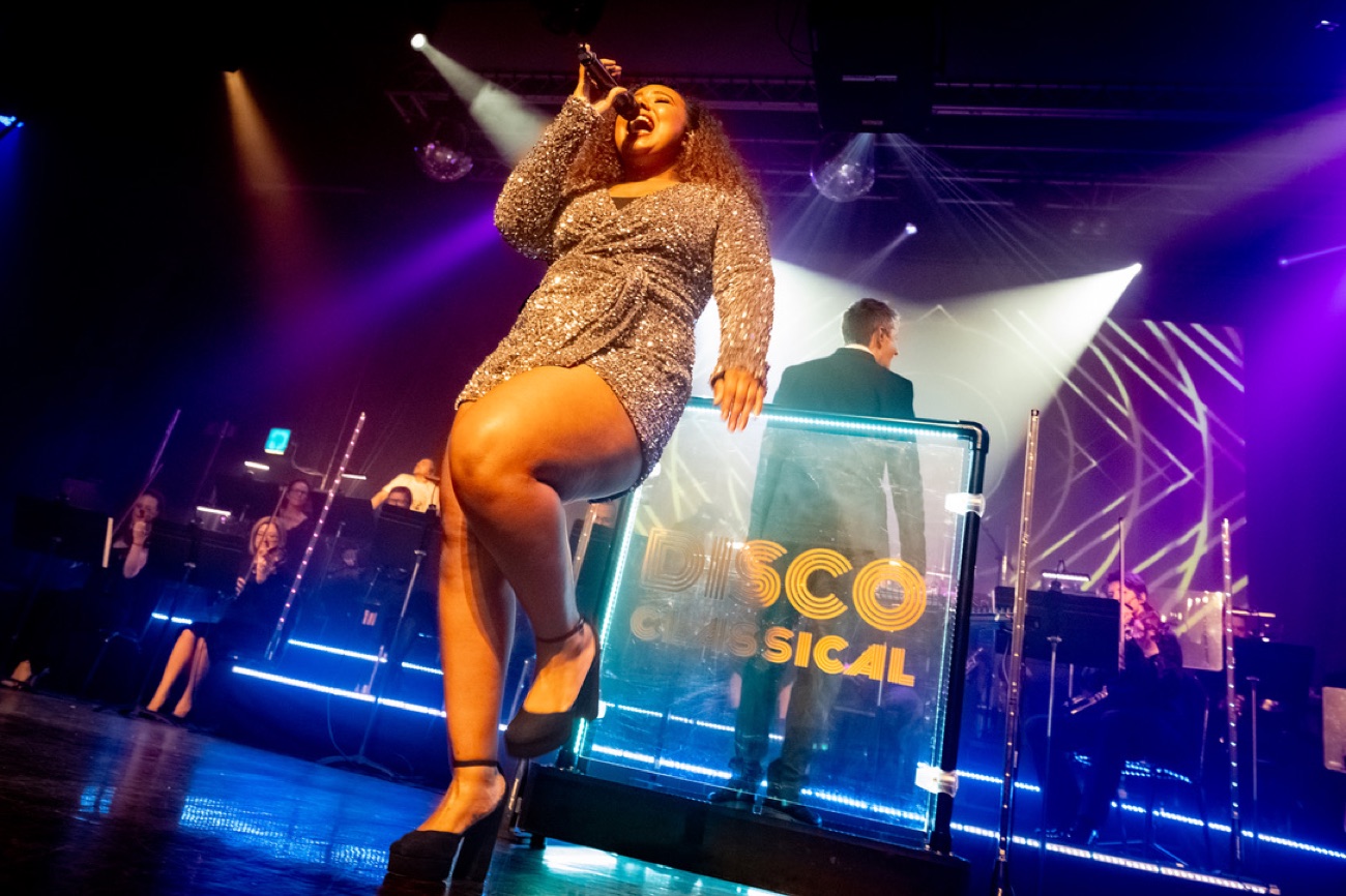 Nicole Battick singing on stage with her band